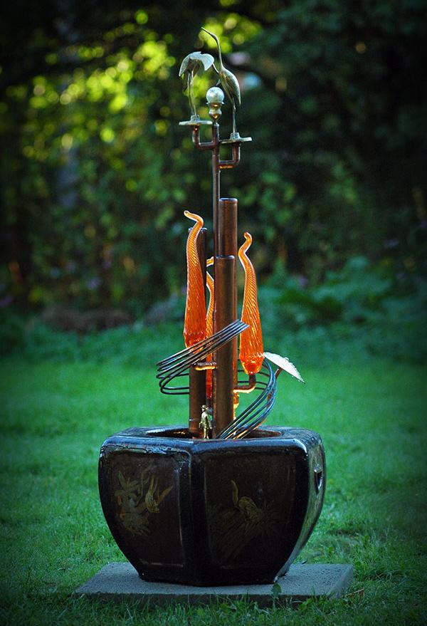 Made from copper tubing, blown glass and Asian inspired brass pieces.